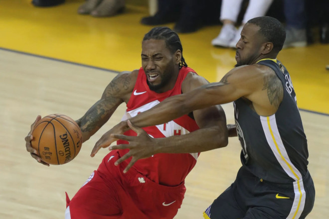 Kawhi Leonard drives to the basket while Andre Iguodala defends during the first quarter of Game 4 of the NBA Finals.