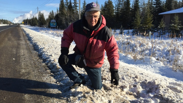 Stephen Kissin, professor emeritus with Lakehead University's geology department, checks out an area alongside Highway 61 where police suspect a meteorite may have hit the ground. 