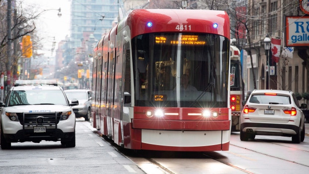 A police car is stopped as traffic moves along the street during the second day of the King Street Transit Pilot involving city streetcars on Monday, November 13, 2017.
