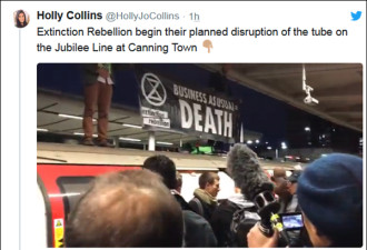 环保抗议者爬上伦敦地铁，愤怒市民一把扯下