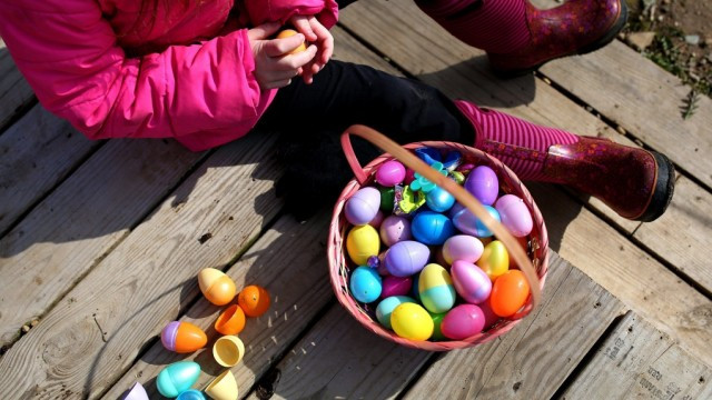 Jessie Liningen, 8, opens an egg after an Easter egg hunt at The Olde World Village in Augusta, Mich., Saturday, March 26, 2016. (Chelsea Purgahn / Kalamazoo Gazette-MLive Media Group via AP)