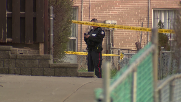 A Toronto police officer is standing on the scene of a shooting in Etobicoke that left a man dead and another seriously injured.