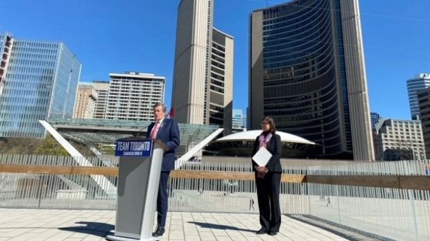 Mayor John Tory and Medical Officer of Health Dr. Eileen de Villa are shown outside Toronto City Hall on Monday. Tory has formally terminated a municipal state of emergency which had been in effect for a total of 777 days. 