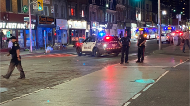 Police are seen at the corner of Yonge and Wellesley streets on June 14, 2022 after a man was stabbed. (Mike Nguyen/CP24)