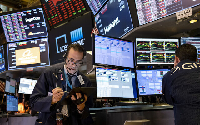 Illustrative: Trader Gregory Rowe works on the floor of the New York Stock Exchange at the end of the trading day, March 16, 2020. (AP/Craig Ruttle)