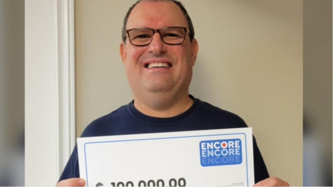 Eric Cohen is seen holding a cheque for $100,000 in this undated image. (OLG)