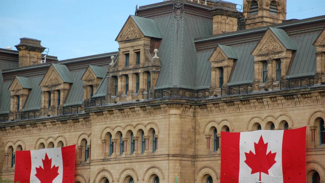 The Canadian flag hangs on a building in Ottawa, Ontario.