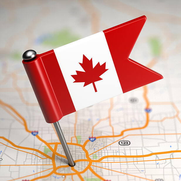 Small Flag of Canada on a Map Background with Selective Focus.-1