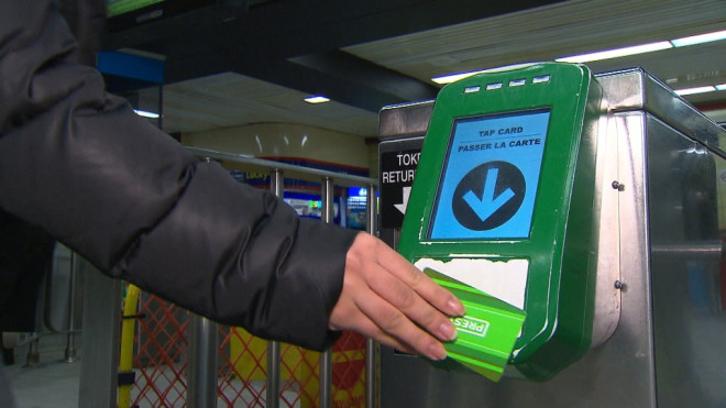 A woman taps a PRESTO fare card on a reader in a TTC station in an undated image. (CP24)