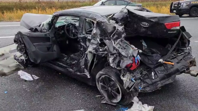 This black car was hit by a transport truck during a seven-vehicle crash on Highway 401 Tuesday, police said. (OPP)