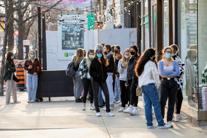 People walk with face masks in Toronto