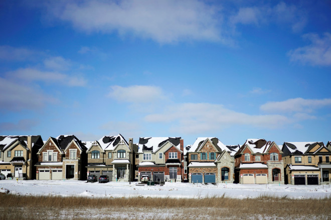 A row of houses stand in a newly built subdivision in East Gwillimbury