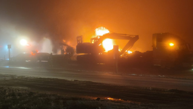 Mike Crampton's photo of flames at the scene of a Dec. 27 crash on the QEII Highway north of Airdrie. RCMP confirm one person was pronounced dead on scene. (image: Mike Crampton)