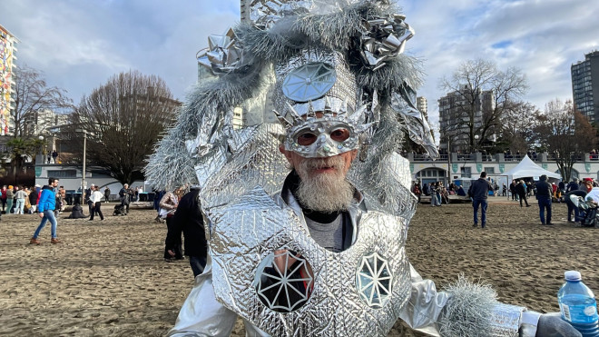 Polar Bear Swim participant in silver festive costume