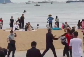 三亚海滩上多名摄影师用照相机互殴 原因竟是...