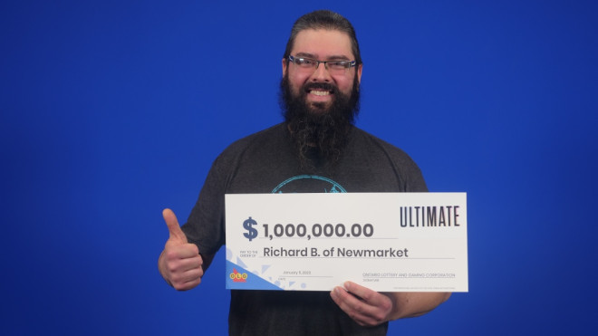 Richard Browning, 39, of Newmarket, Ont., holds his big cheque at the OLG Prize Centre in Toronto after winning Instant Ultimate (GAme #2123). (Supplied)