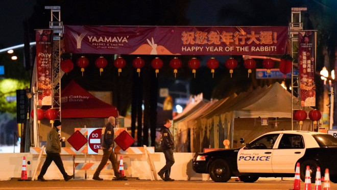  FBI agents walk near a scene where a shooting took place in Monterey Park, Calif., Sunday, Jan. 22, 2023. Nine people were killed in a mass shooting late Saturday in a city east of Los Angeles following a Lunar New Year celebration that attracted thousands, police said. (AP Photo/Jae C. Hong)