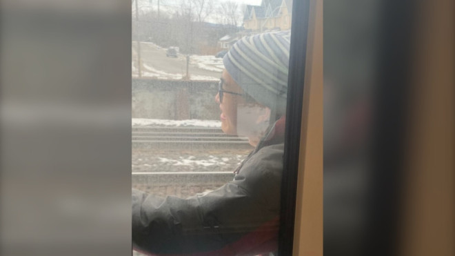 A passenger appears to cling onto a GO Train on Feb. 5. (Supplied)