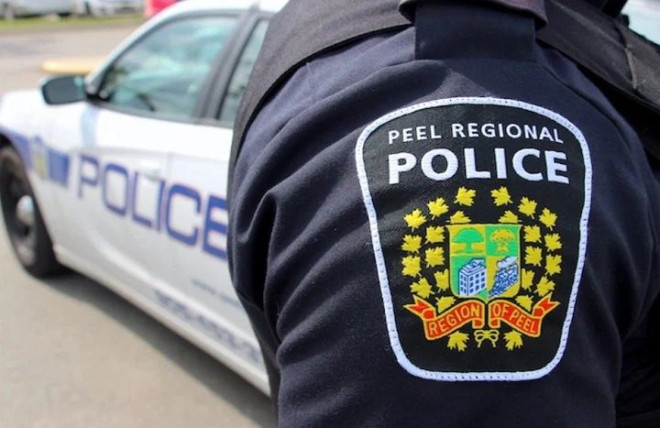 A Peel Regional Police cruiser and officer are seen at the 12 Division station. 