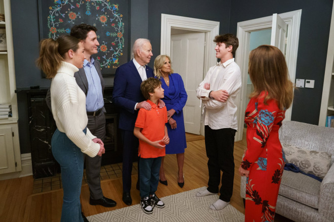 Prime Minister Justin Trudeau, Sophie Grégoire Trudeau, President Joe Biden, First Lady Jill Biden, Xavier Trudeau, Ella-Grace Trudeau, and Hadrien Trudeau are standing inside and talking.