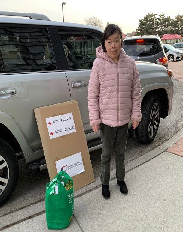 A person holding a box Description automatically generated with low confidence