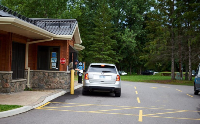 car pulled up to gatehouse in park