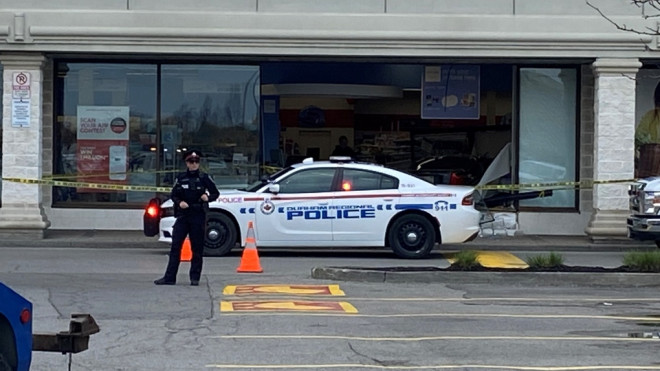 Police respond after a vehicle crashed into a Shoppers Drug Mart in Pickering, Ont. on April 25, 2023. 