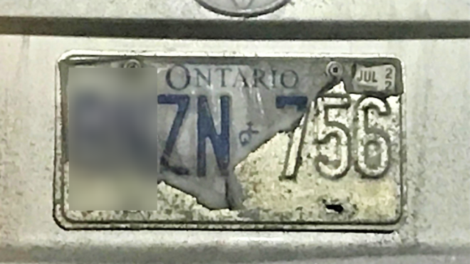 A licence plate can be seen above. 