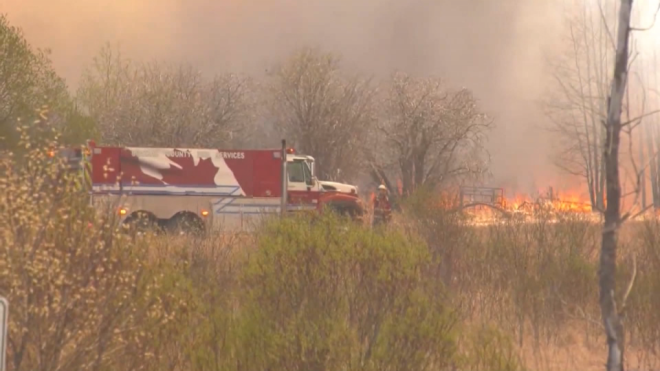 A wildfire burns near Drayton Valley, Alta., on May 4, 2023. 