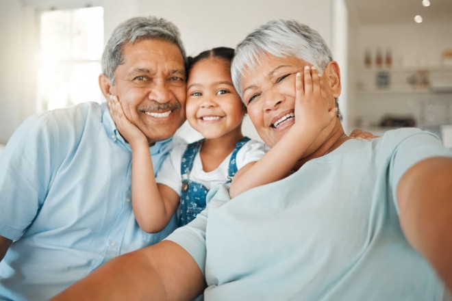 Granddaughter hugging grandparents