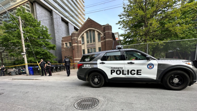 Officials investigate a fatal stabbing near Charles and Yonge streets on May 15, 2023.