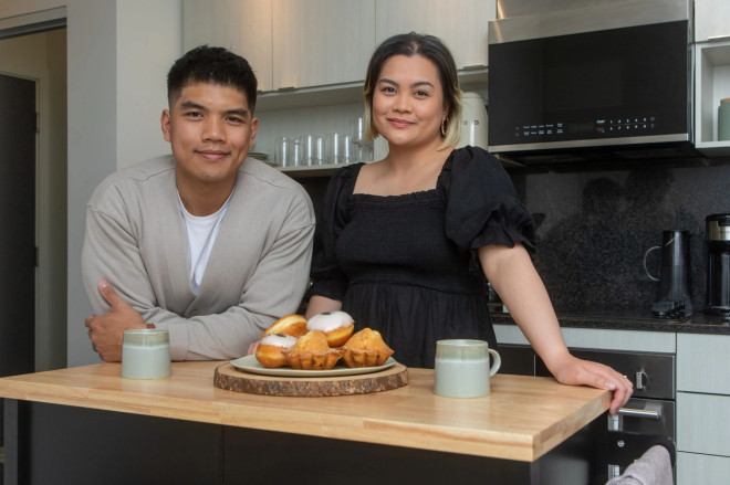Marion Rana, 31, and Jarelle Gabison, 34, at home in their kitchen in their one-bedroom condo near Bloor and Islington