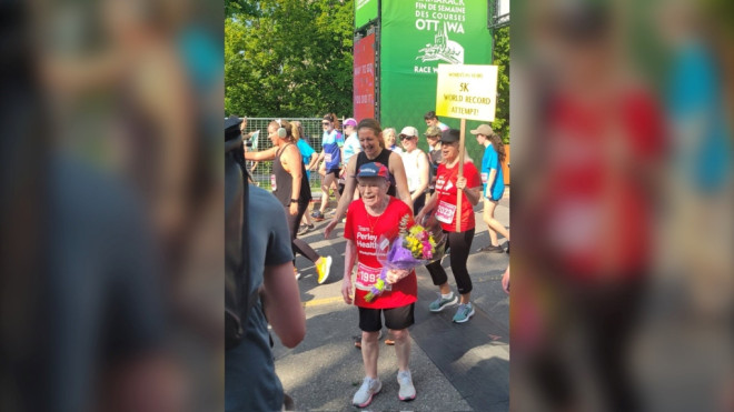 Rejeanne Fairhead of Ottawa crosses the finish line at the Tamarack Ottawa Race Weekend after setting a new world record for women 95+ for five kilometres. (Tamarack Ottawa Race Weekend/Twitter)