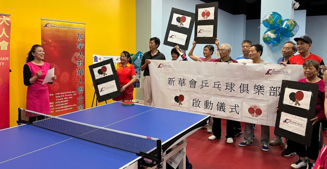 A group of people holding signs  Description automatically generated