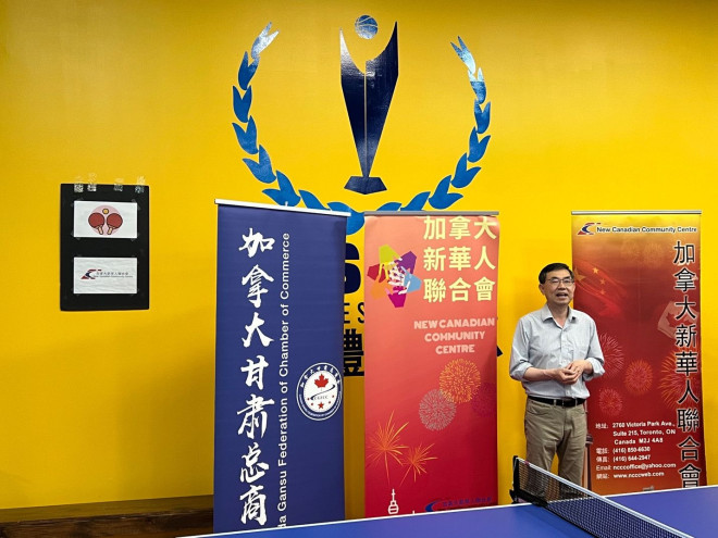 A person standing in front of a ping pong table  Description automatically generated