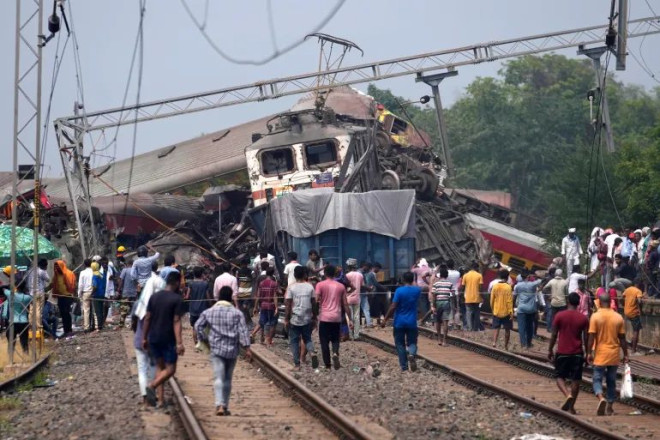 Rescuers work at the site of passenger trains that derailed in Balasore district, in the eastern Indian state of Orissa