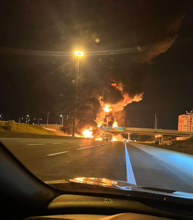 A driver takes a photo of the fiery explosion following a crash on Highway 401 in Pickering on June 20, 2023.