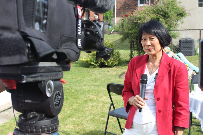 Olivia being interviewed while standing in front of a TV camera.