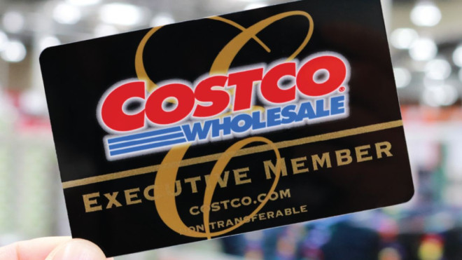 Costco membership card in hand