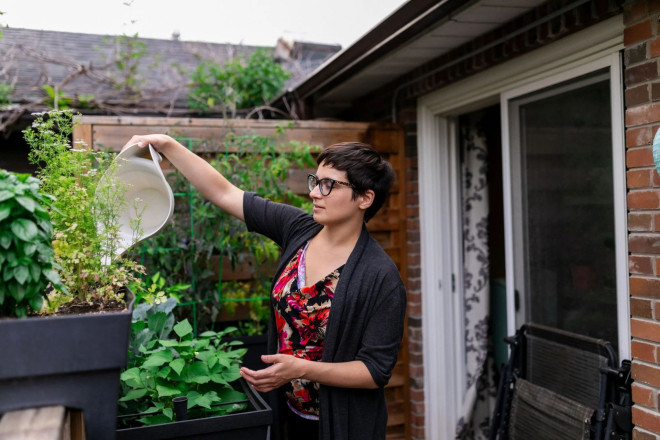 Sophie Rogowska watering her plants in St. Clair West Village