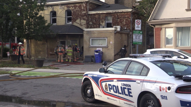 A London Police cruiser guards the scene while firefighters convene outside 538 Dundas St. on Monday Oct. 9, 2023 (Source: Brent Lale/CTV News London)