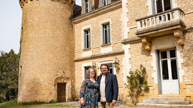 Stephen and Sara Cole stand in front of the chateau where they now live in Saint-Germain-des-Prés, France. (Manor & Maker)