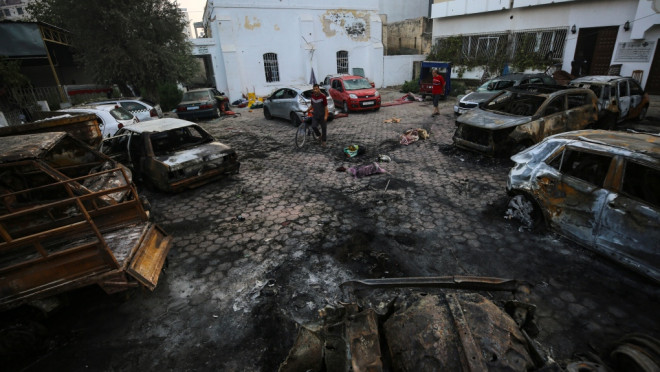 Palestinian men look over the site of a deadly explosion at al-Ahli Hospital in Gaza City, Wednesday, Oct. 18, 2023. (AP Photo/Abed Khaled)