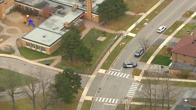 Toronto police cruisers can be seen near where a child was reportedly struck by a vehicle Tuesday morning. (CP24)