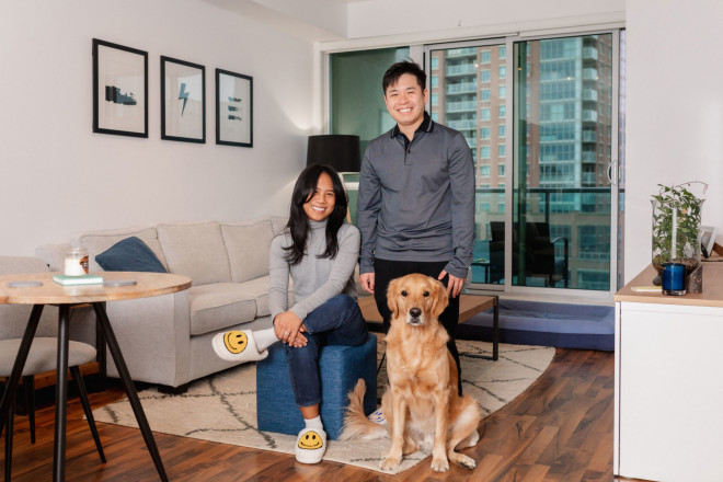Ginette Nguyen, 29, and Michael Nguyen, 33, in their one-bedroom condo in Liberty Village with their golden retriever, Harlo