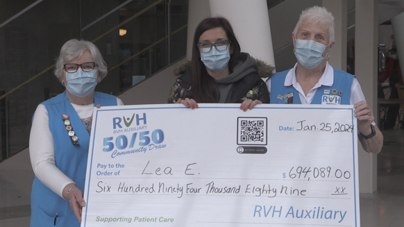 Lea Engles (C) is handed her large cheque after winning the January 25, 2024, RVH Auxiliary 50/50 draw. (CTV News/Catalina Gillies)