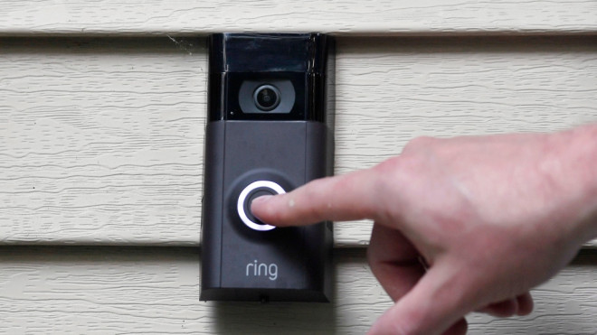 FILE - In this July 16, 2019, file photo, Ernie Field pushes the doorbell on his Ring doorbell camera at his home in Wolcott, Conn. Amazon says it has considered adding facial recognition technology to its Ring doorbell cameras. (AP Photo/Jessica Hill, File)