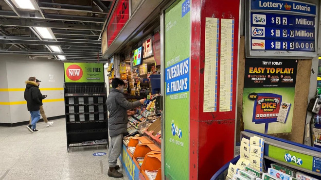 A person buying tickets at OLG kiosk in Toronto.