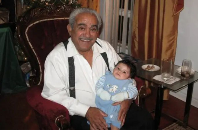 Walter holding one of his grandchildren