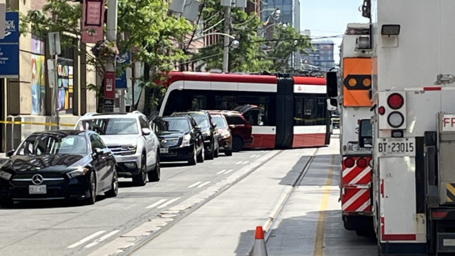 Three people were injured after a car and streetcar collided on King Street East at Frederick Street